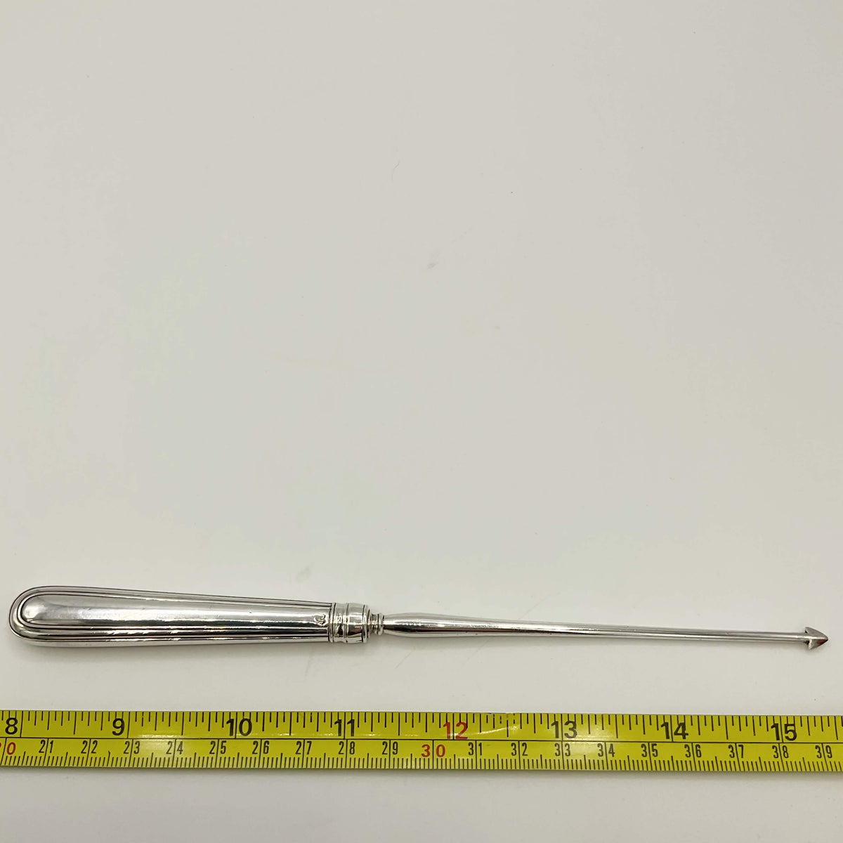 Antique 1871 Victorian sterling silver arrowhead tool, vintage accessories with intricate details and historic craftsmanship.