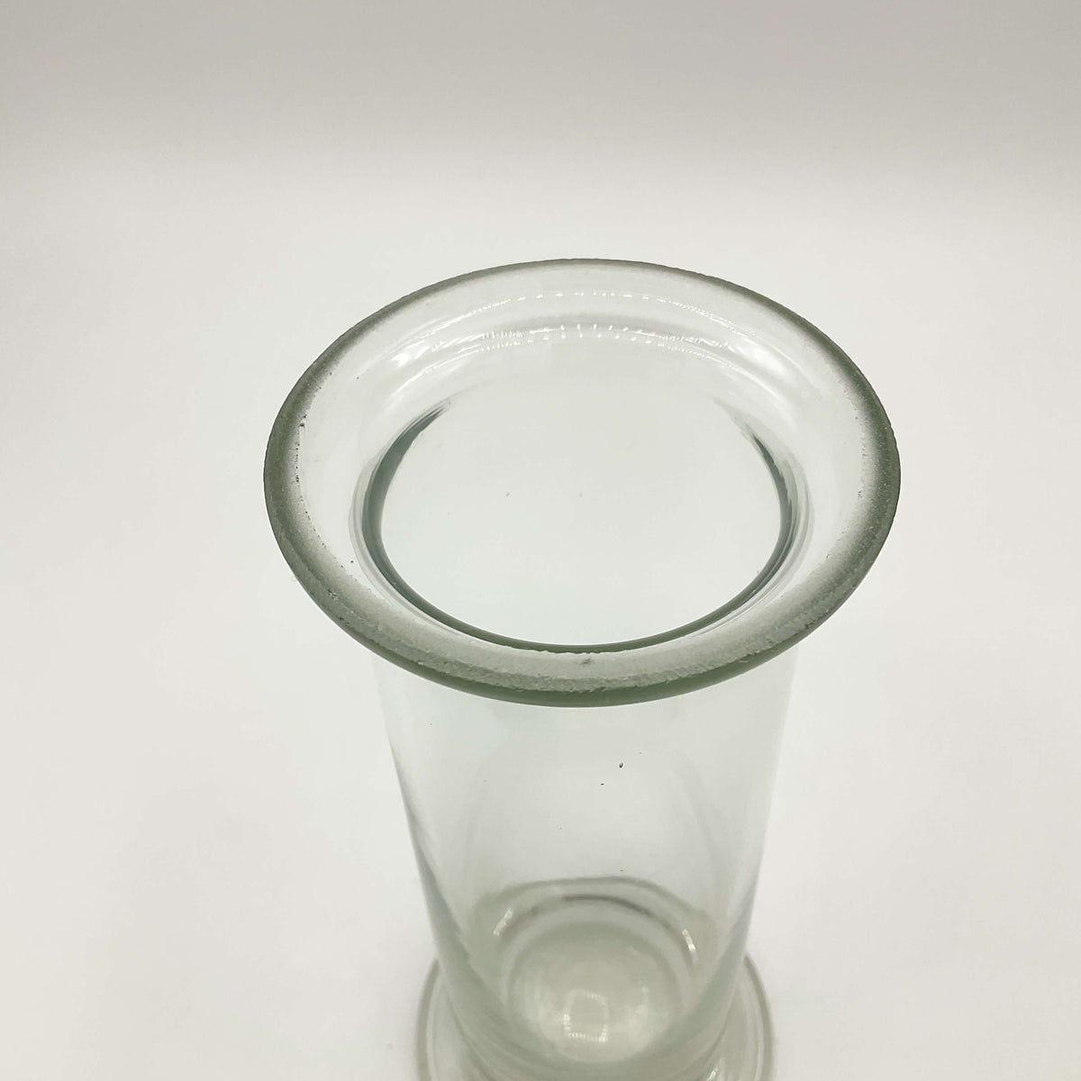 Clear glass vase with vintage cylinder design by Beeches Vintage, featuring a sleek, transparent container ideal for floral arrangements.