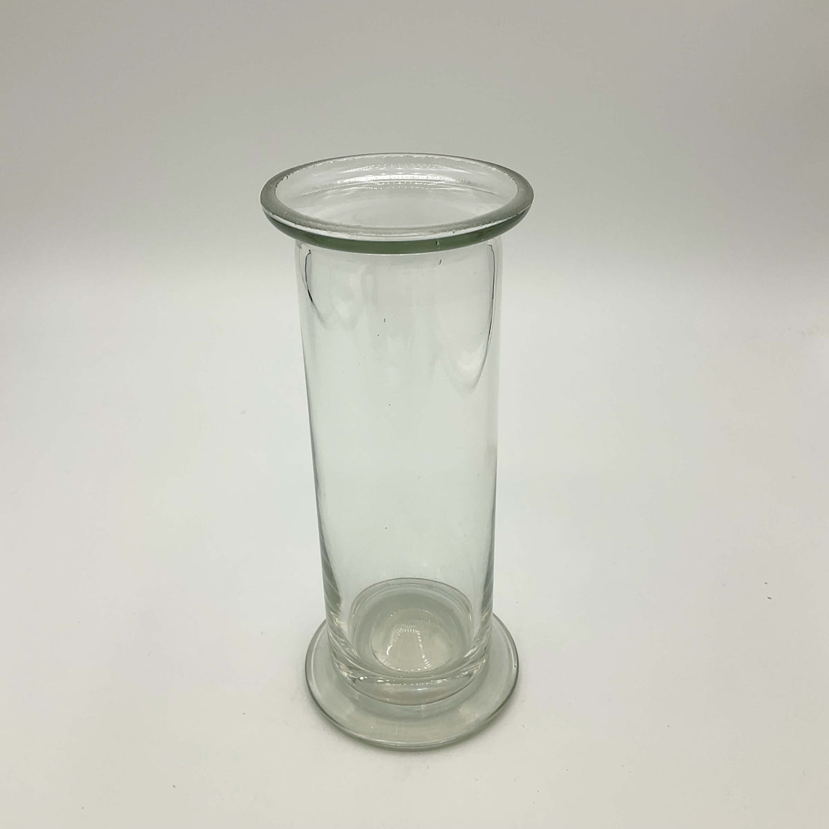 Clear glass vase with vintage cylinder design by Beeches Vintage, showcasing a sleek, transparent vessel for floral arrangements.