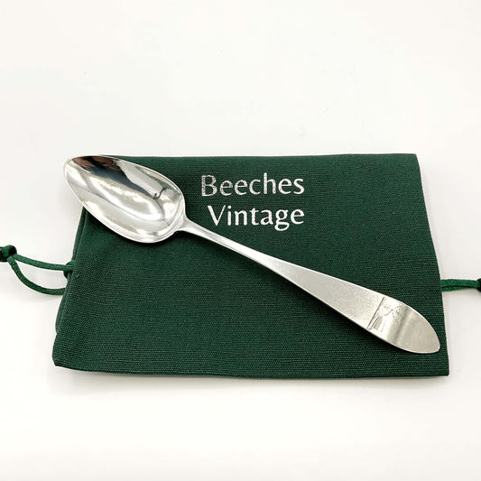 Antique 1700s Georgian sterling silver dessert spoon with ornate handle, crafted by Beeches Vintage.