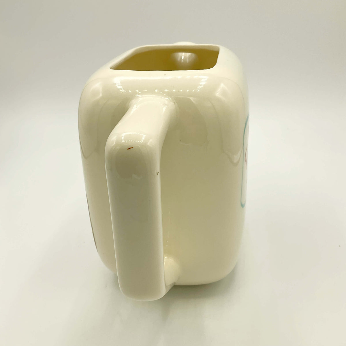 View of handle of Canadian Club Whisky Water Jug  on a white background