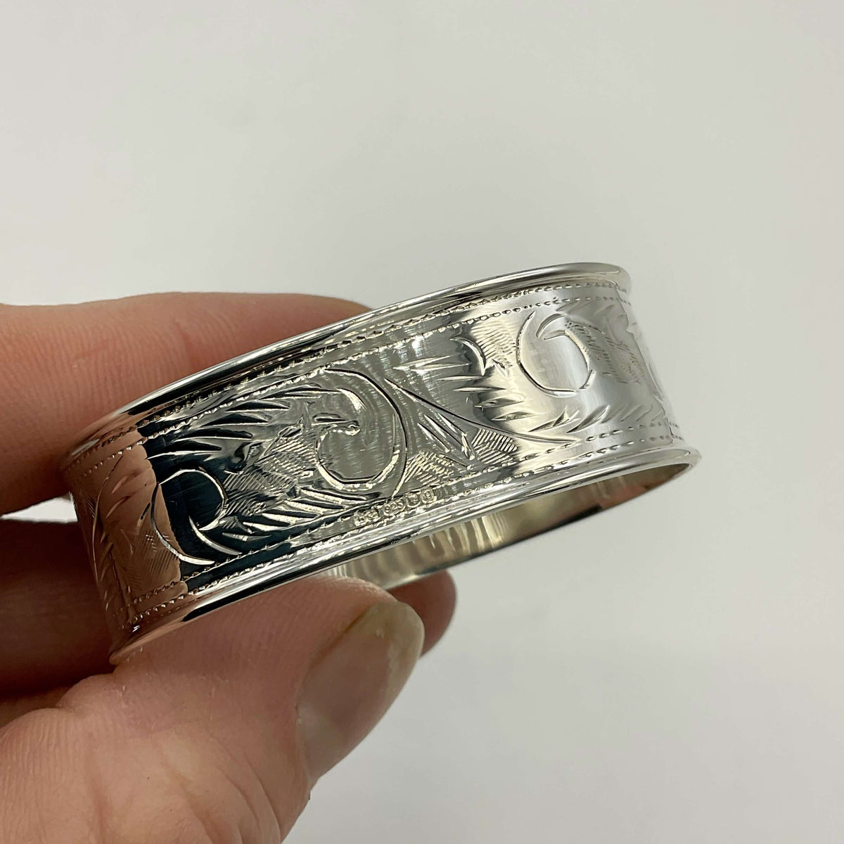 Solid sterling silver napkin ring with intricate design from Beeches Vintage, showcasing craftsmanship and elegant metalwork.