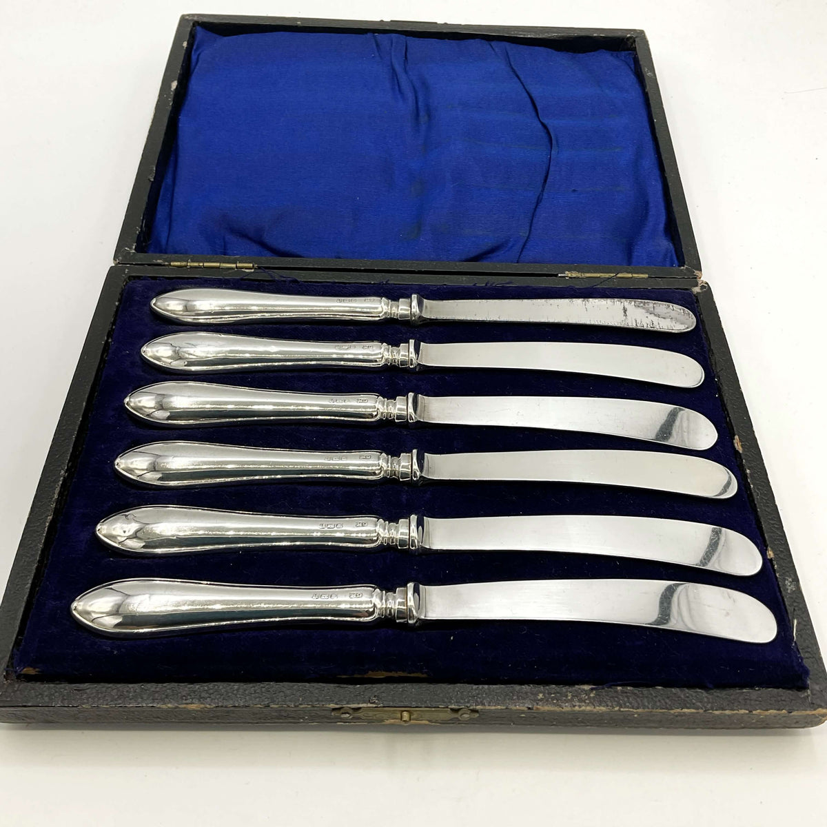 Antique set of silver tea knives in a presentation box with a white background