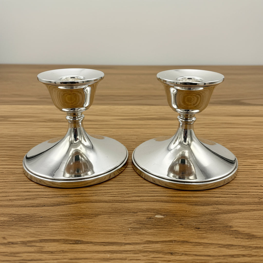 Pair of silver candlestick holders on a on a white background 