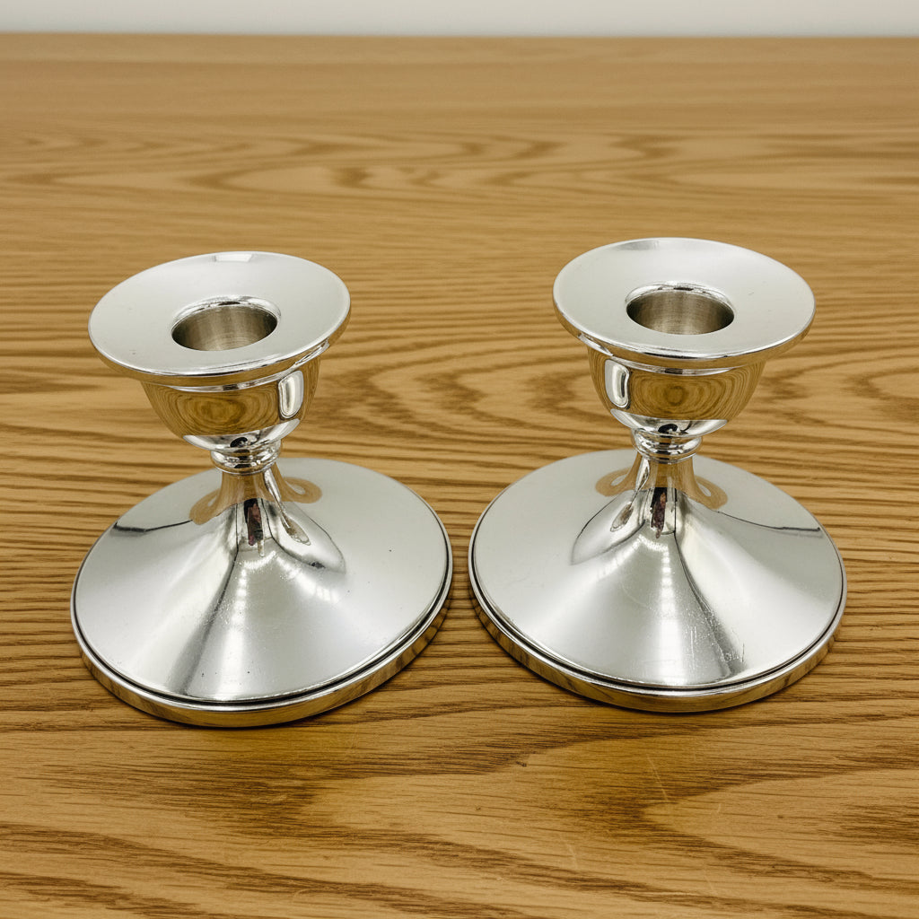 Pair of silver candlestick holders on a on a white background 