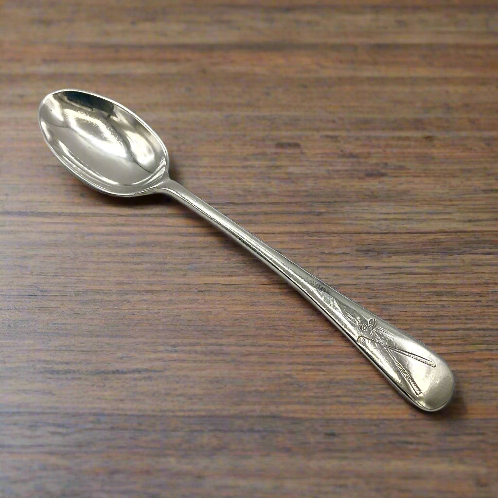 Silver coffee spoon on a wooden table