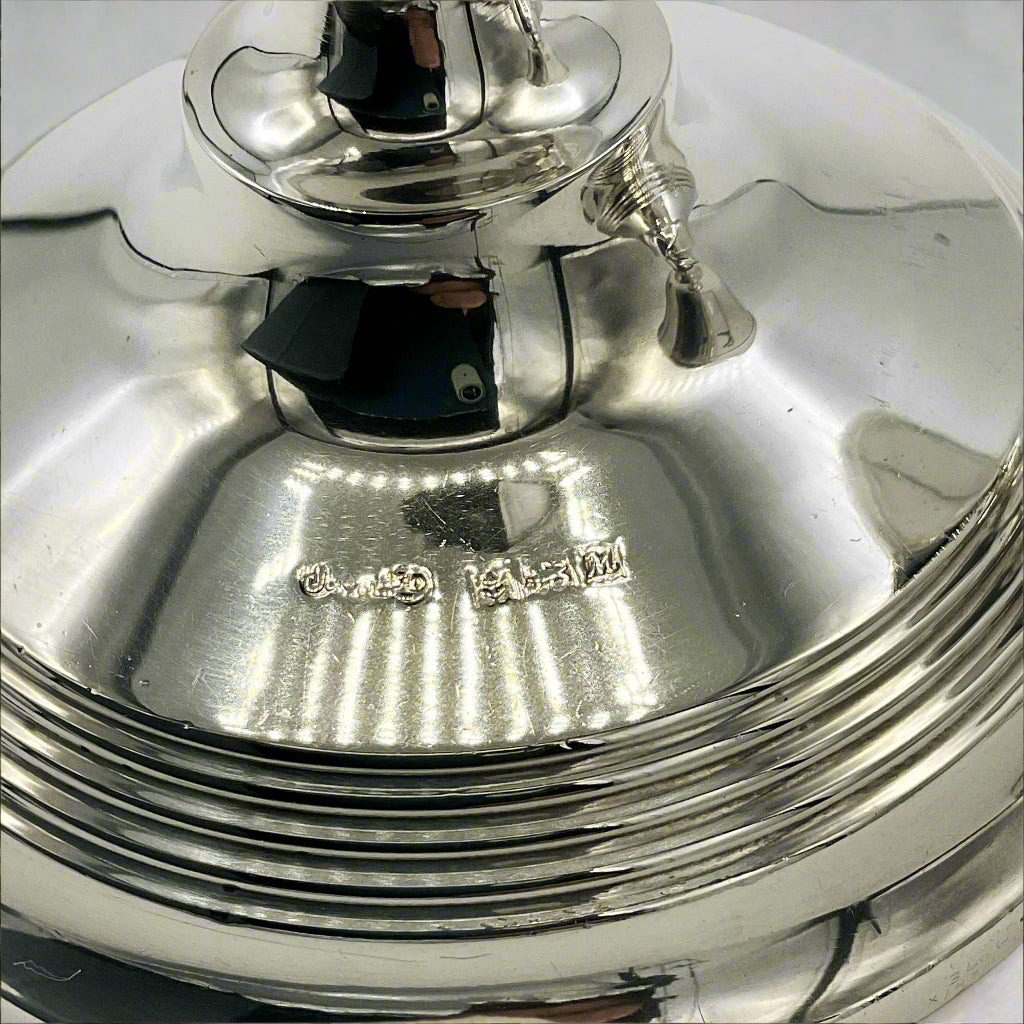 maker's mark and hallmarks on the side of a silver candle holder
