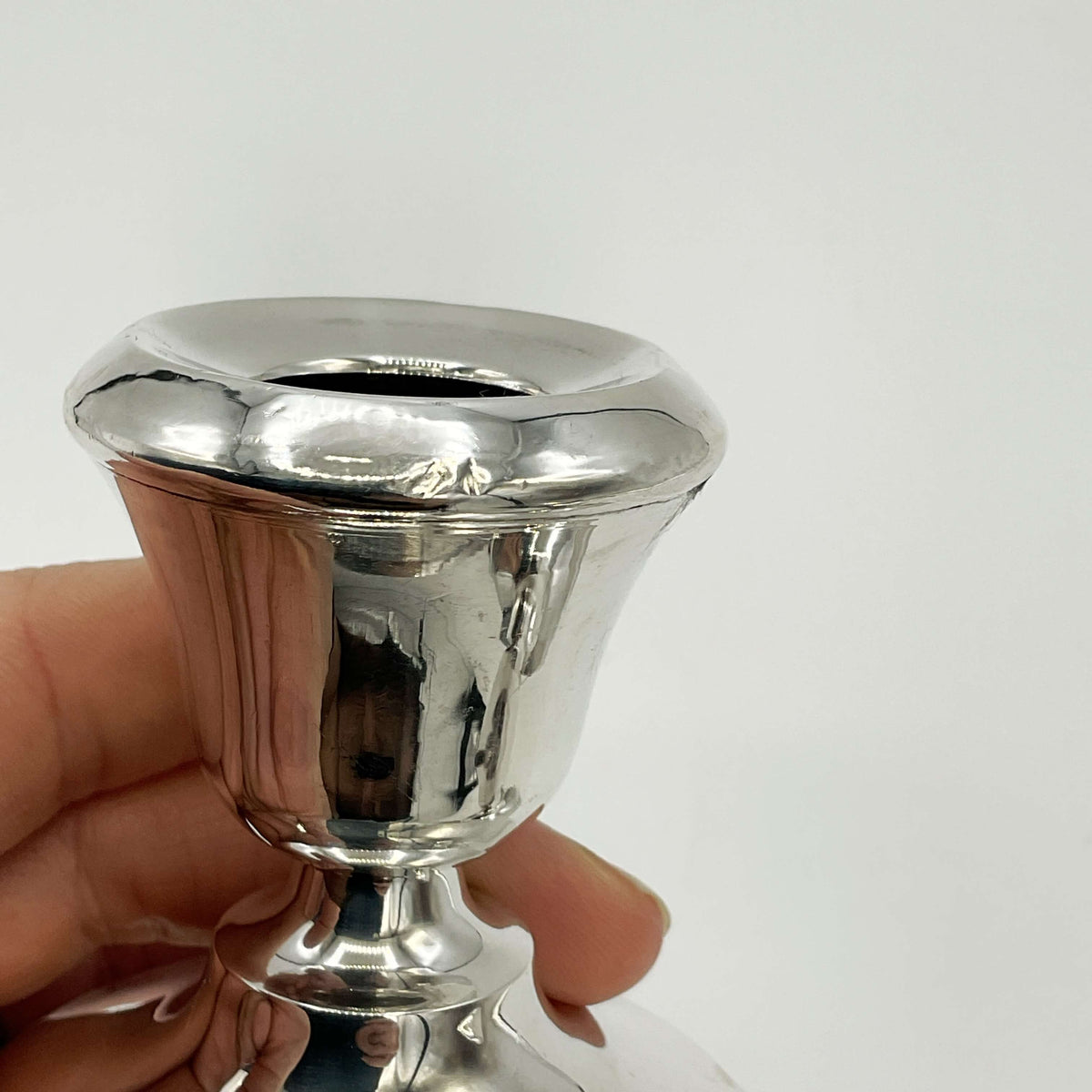 small dent in side of rim of vintage silver candle holder