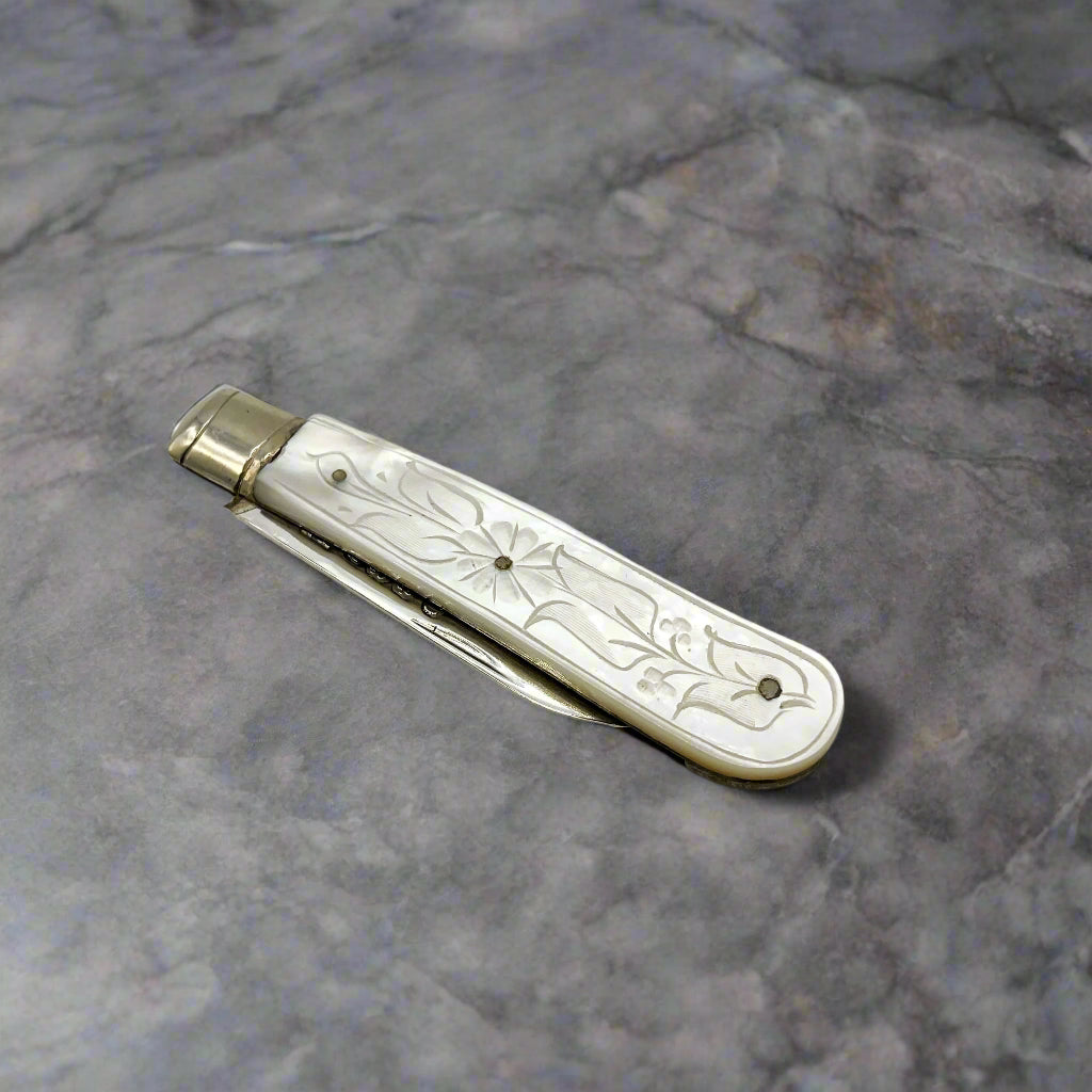 Vintage 1934 sterling silver fruit knife with detailed handle from Beeches Vintage, showcasing elegant craftsmanship and antique design.