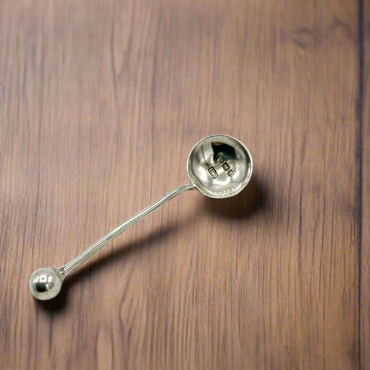 Silver ladle on a wooden surface
