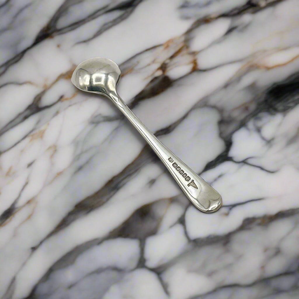 Silver spoon on a marble workbench 