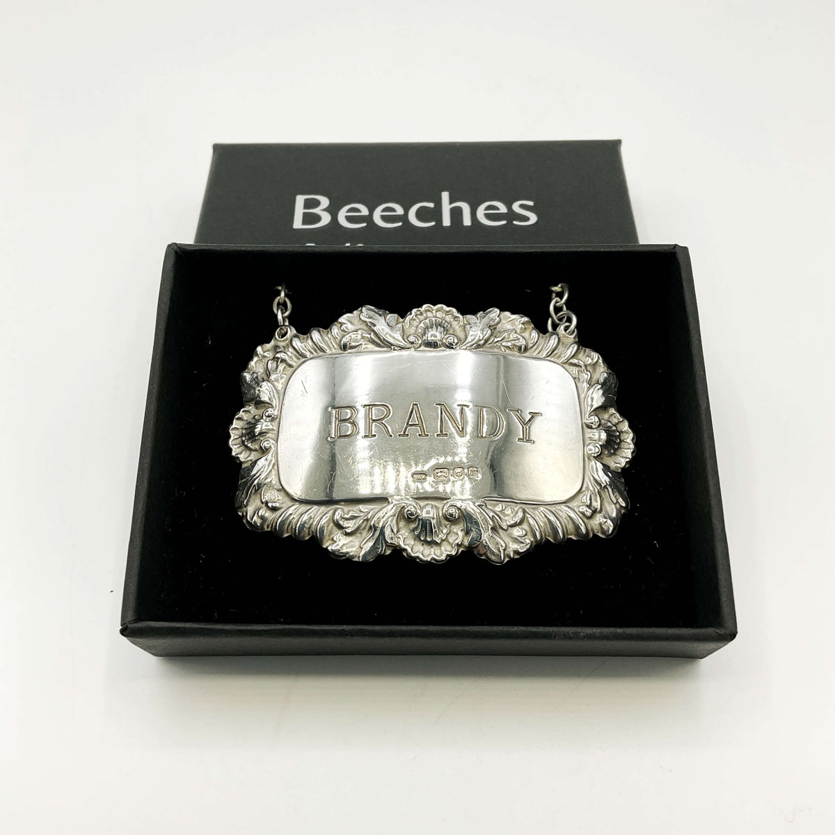Silver 'BRANDY' decanter label in a black box with 'Beeches Vintage’ branding and a white background 