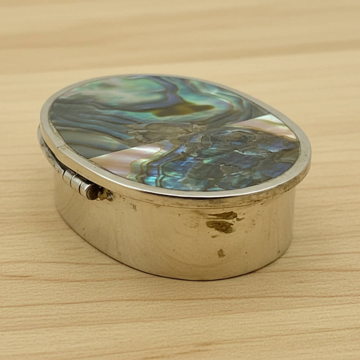 Side view of Mexican Abalone Shell Pill Box on wood table