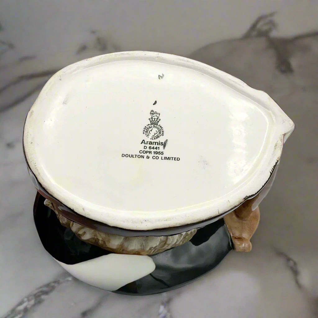 Base of Large Aramis toby jug on marble background.