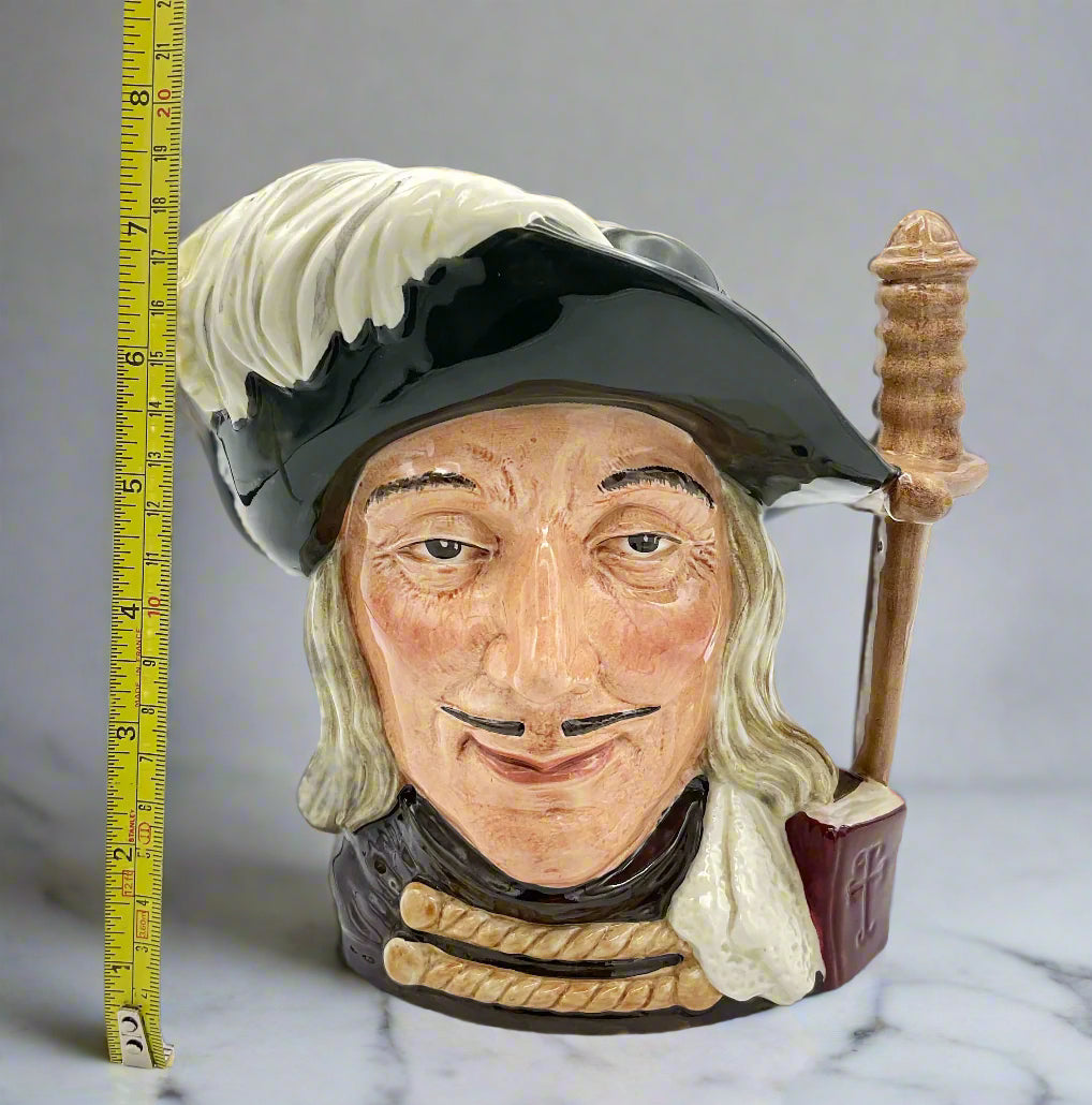 Large Aramis China collectible toby jug on grey marble background next to a tape measure.