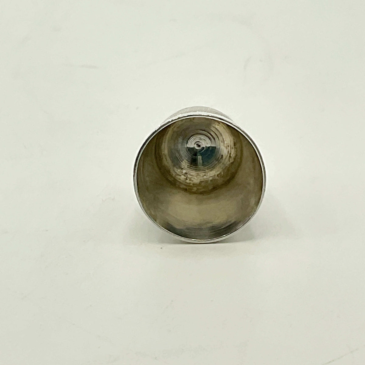 Silver thimble on a white background