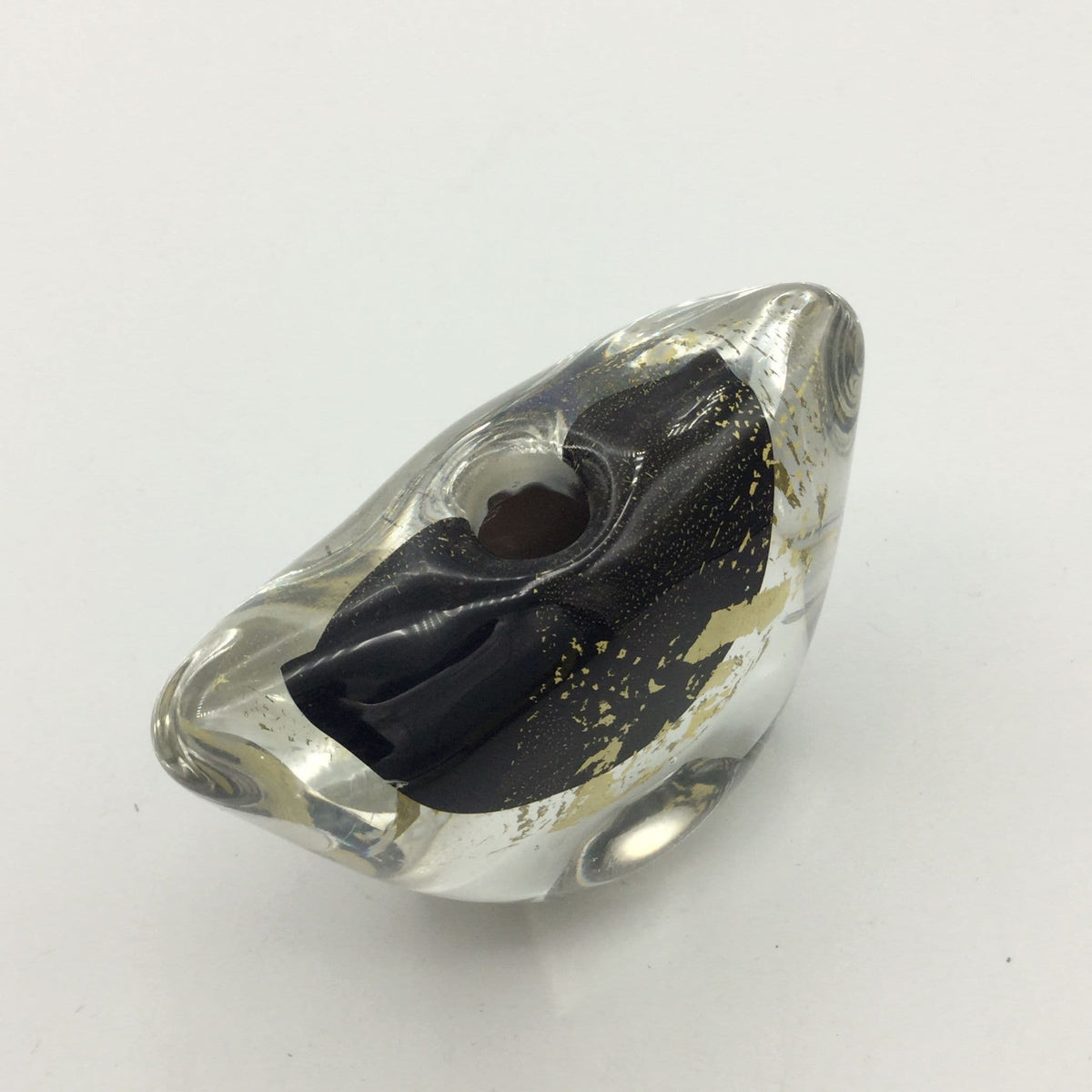 A clear glass art deco style vase with a black interior lining and scattered gold leaf accents, shown on a plain white background.