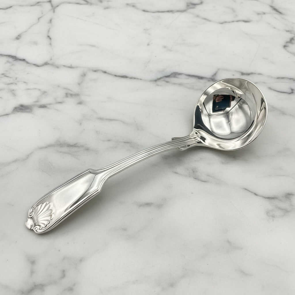 Small silver-plated sauce ladle by Beeches Vintage, showing its elegant handle and polished bowl for serving sauces.