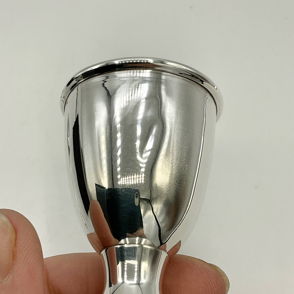 Sterling Silver Egg Cup held in a hand against a white background