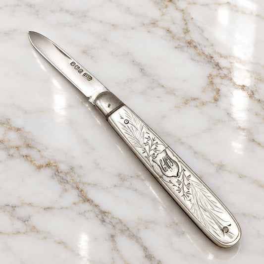 Vintage 1924 Sterling Silver Fruit Knife on a marble surface