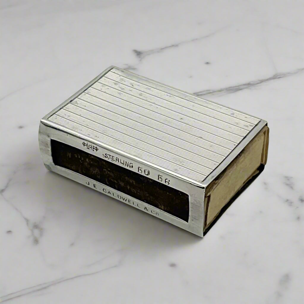 Silver matchbox on a marble surface