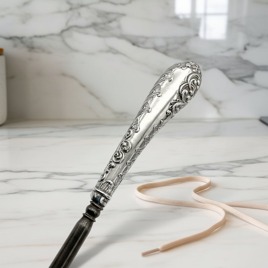 beautiful detailing on silver handle featuring scrolls on button hook
