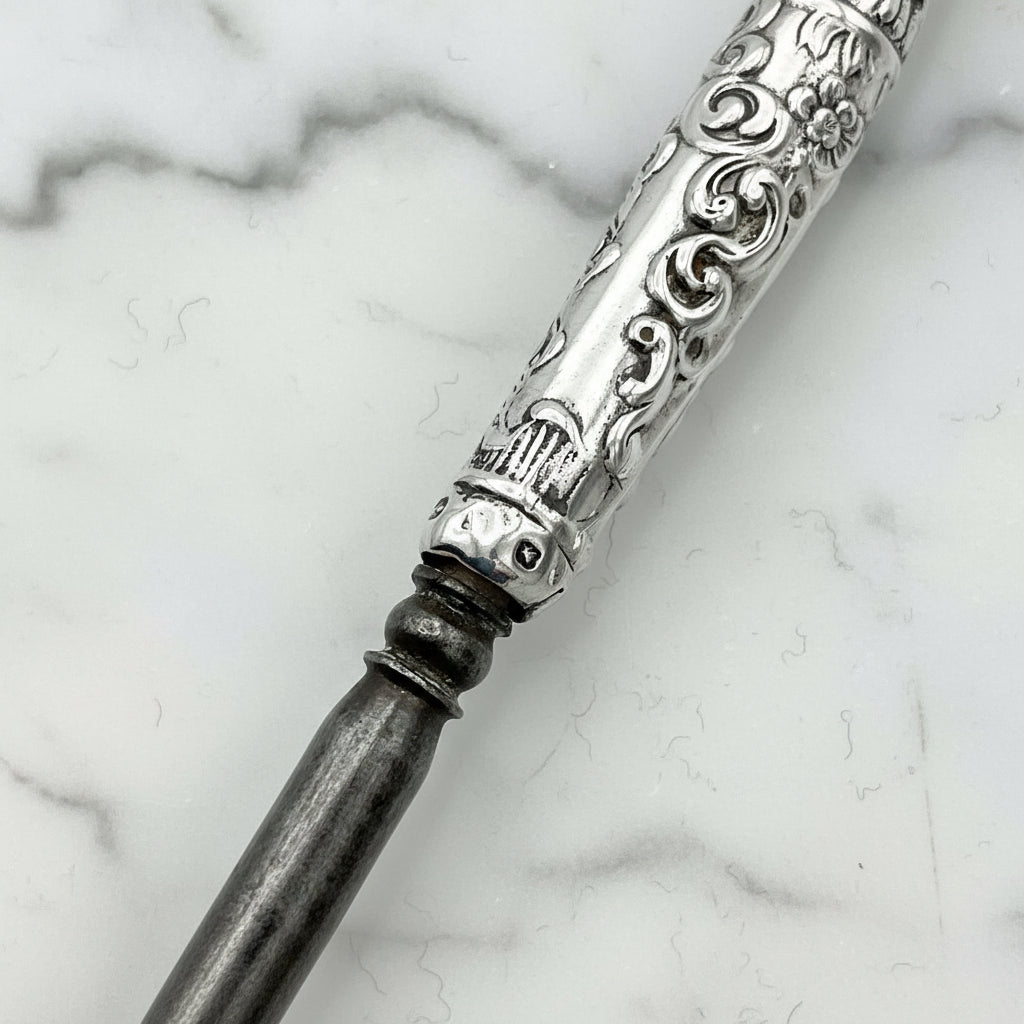 the silver hallmarks on the button hook handle