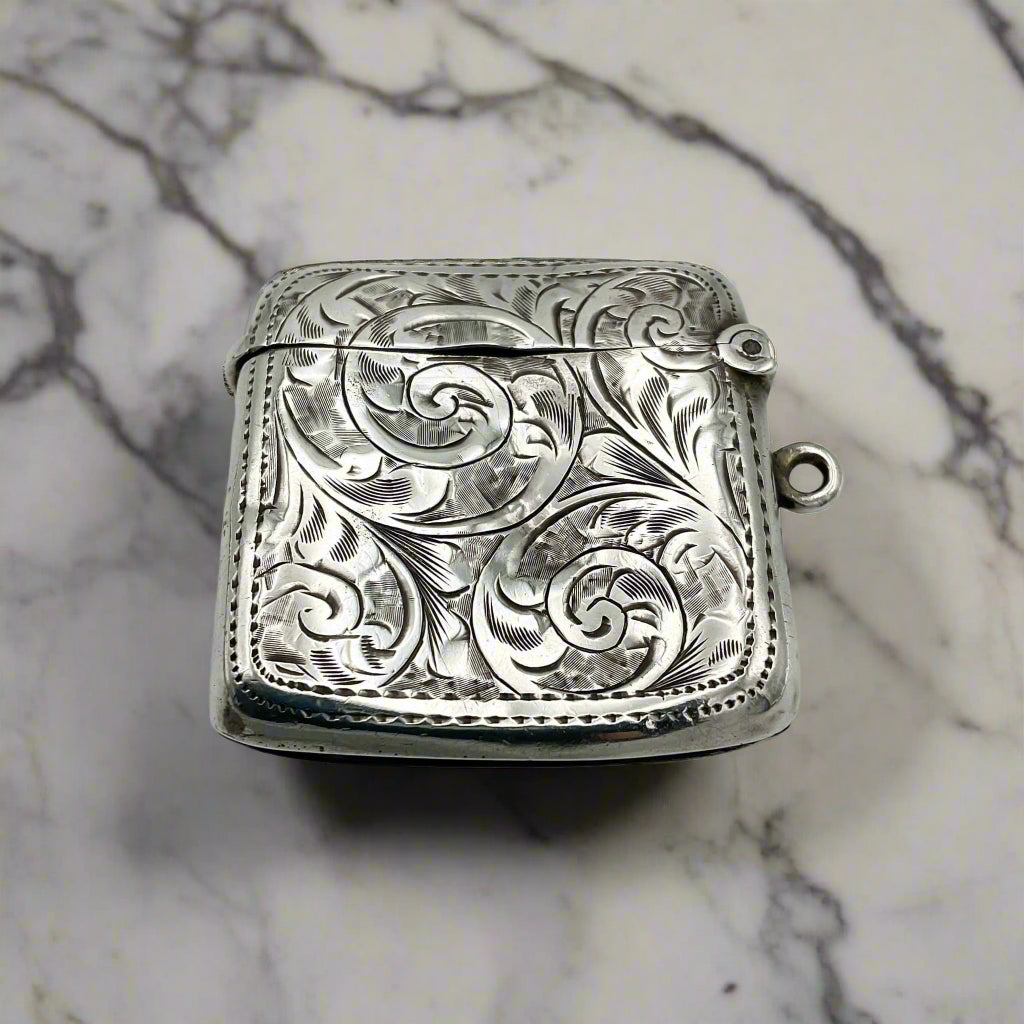 Silver engraved vesta on a marble background