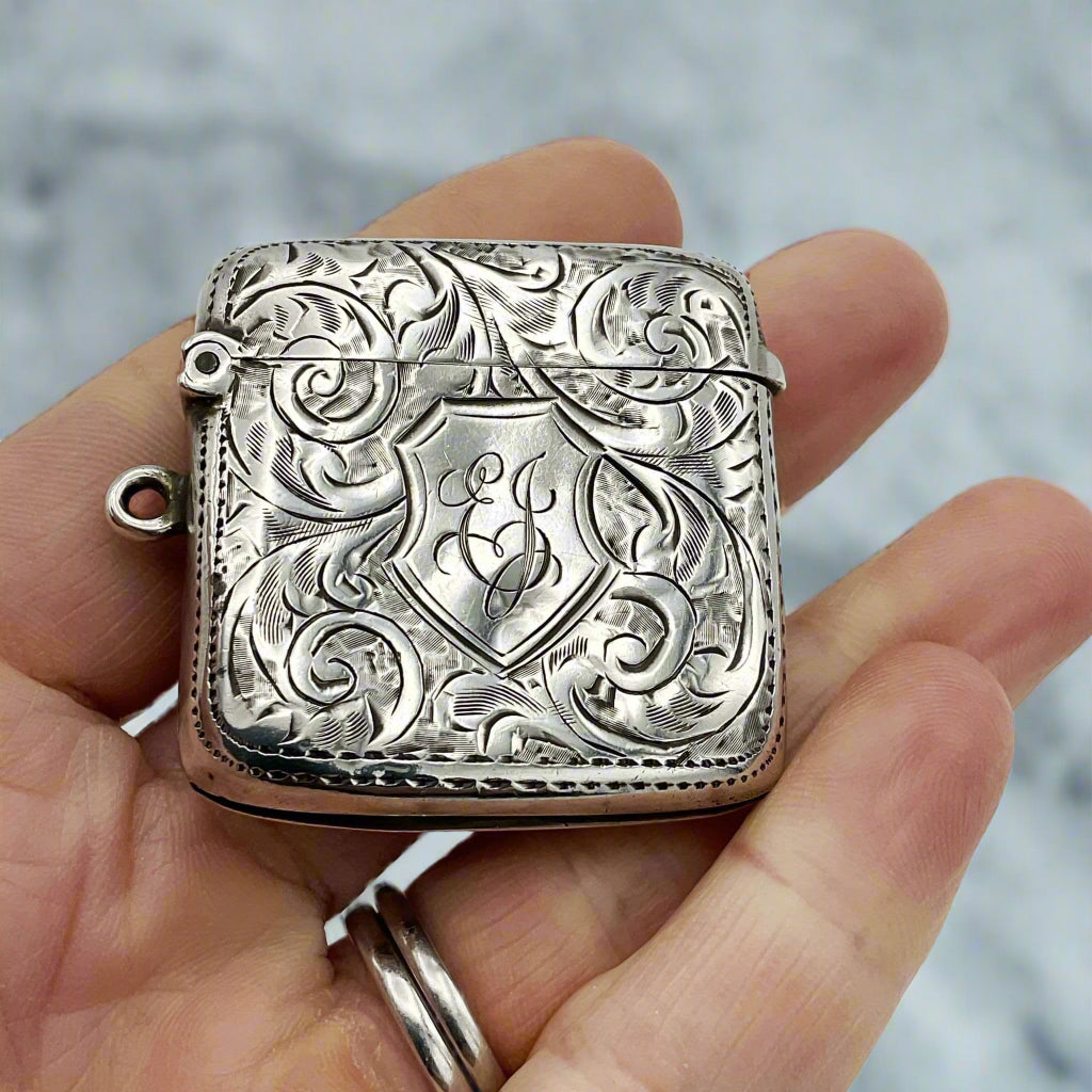 Silver Vesta in hand with kitchen in background 