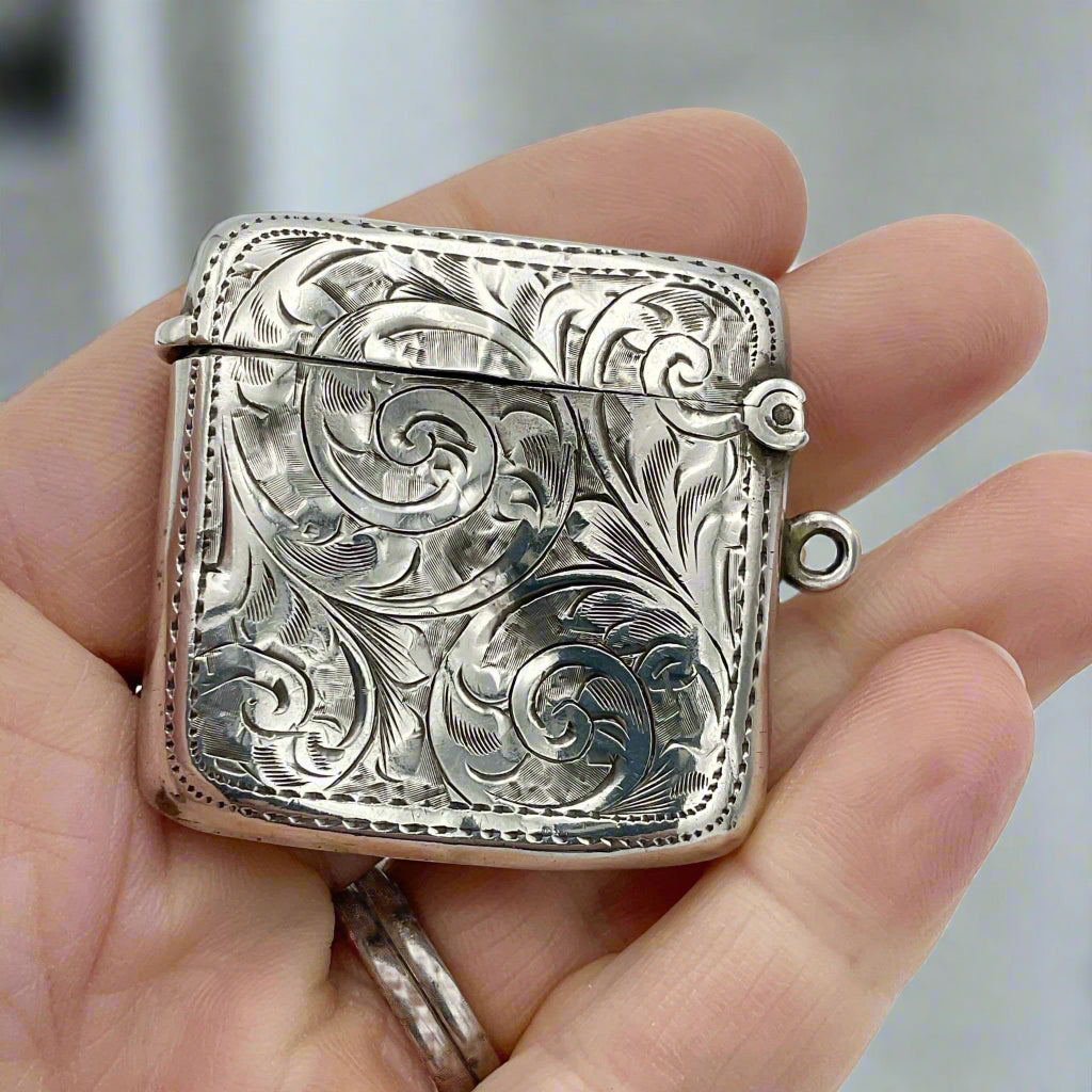 Silver Vesta in hand with a marble kitchen in the background 