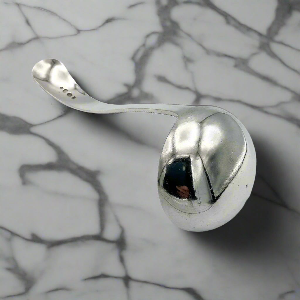 Silver ladle on a marble background