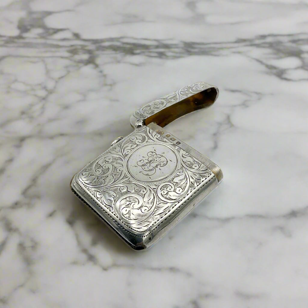 Silver engraved Vesta case on a marble surface