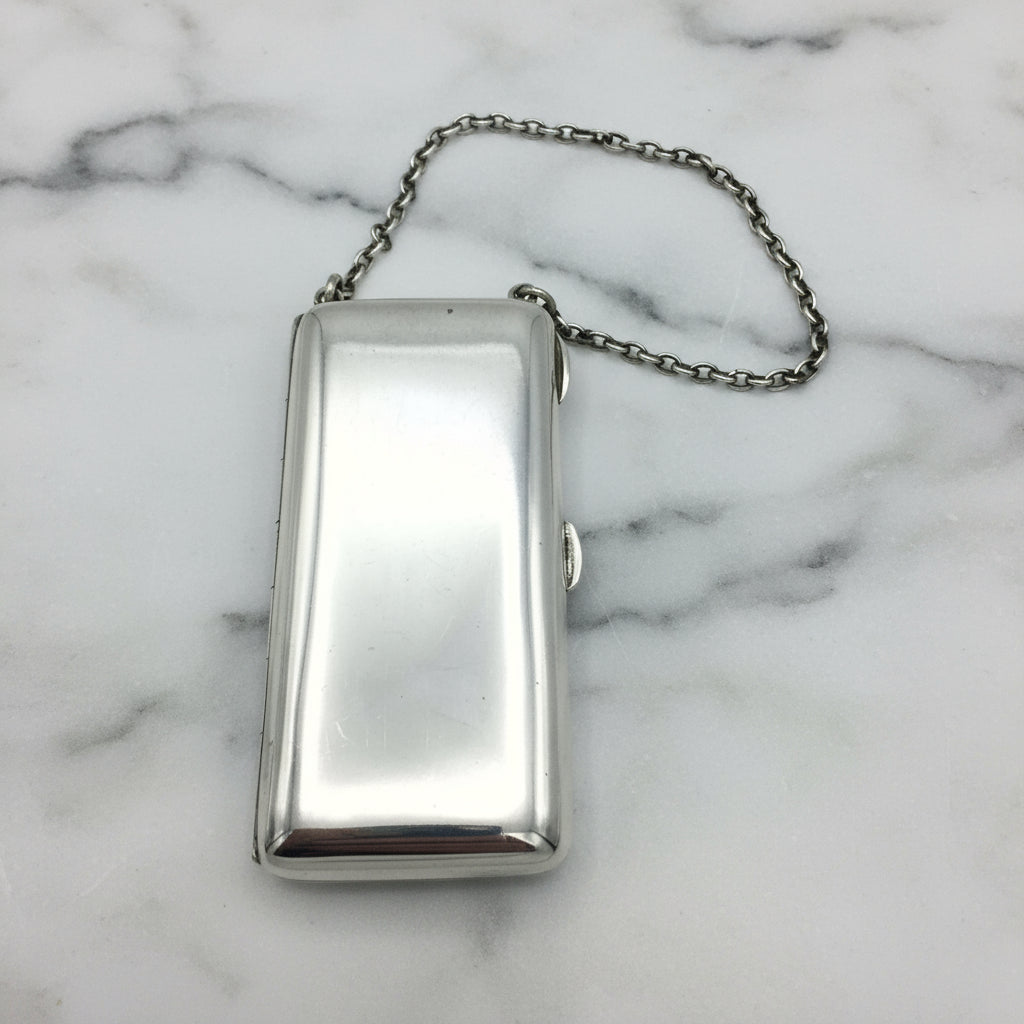 Shiny Silver case with chatelaine chain on marble background