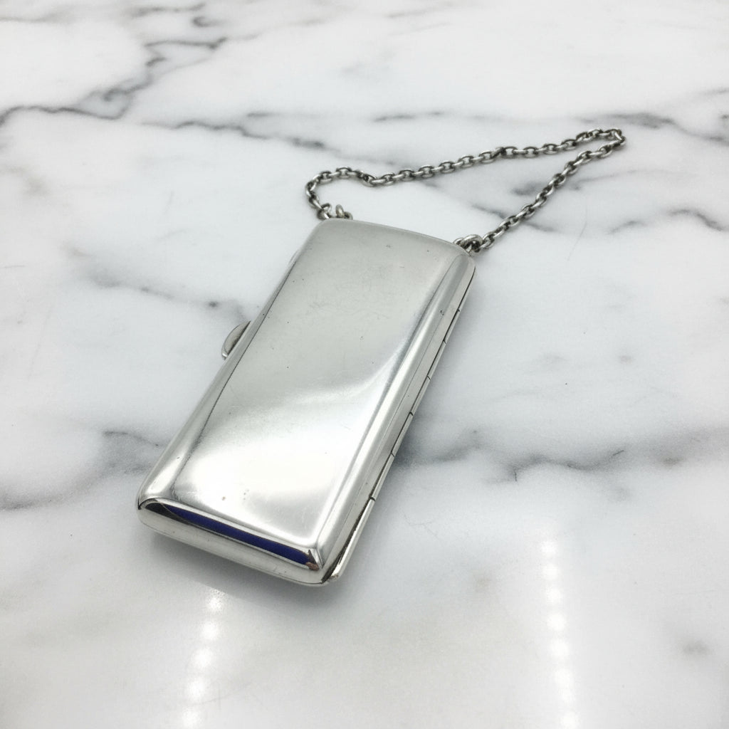Shiny Silver case with chatelaine chain on marble background