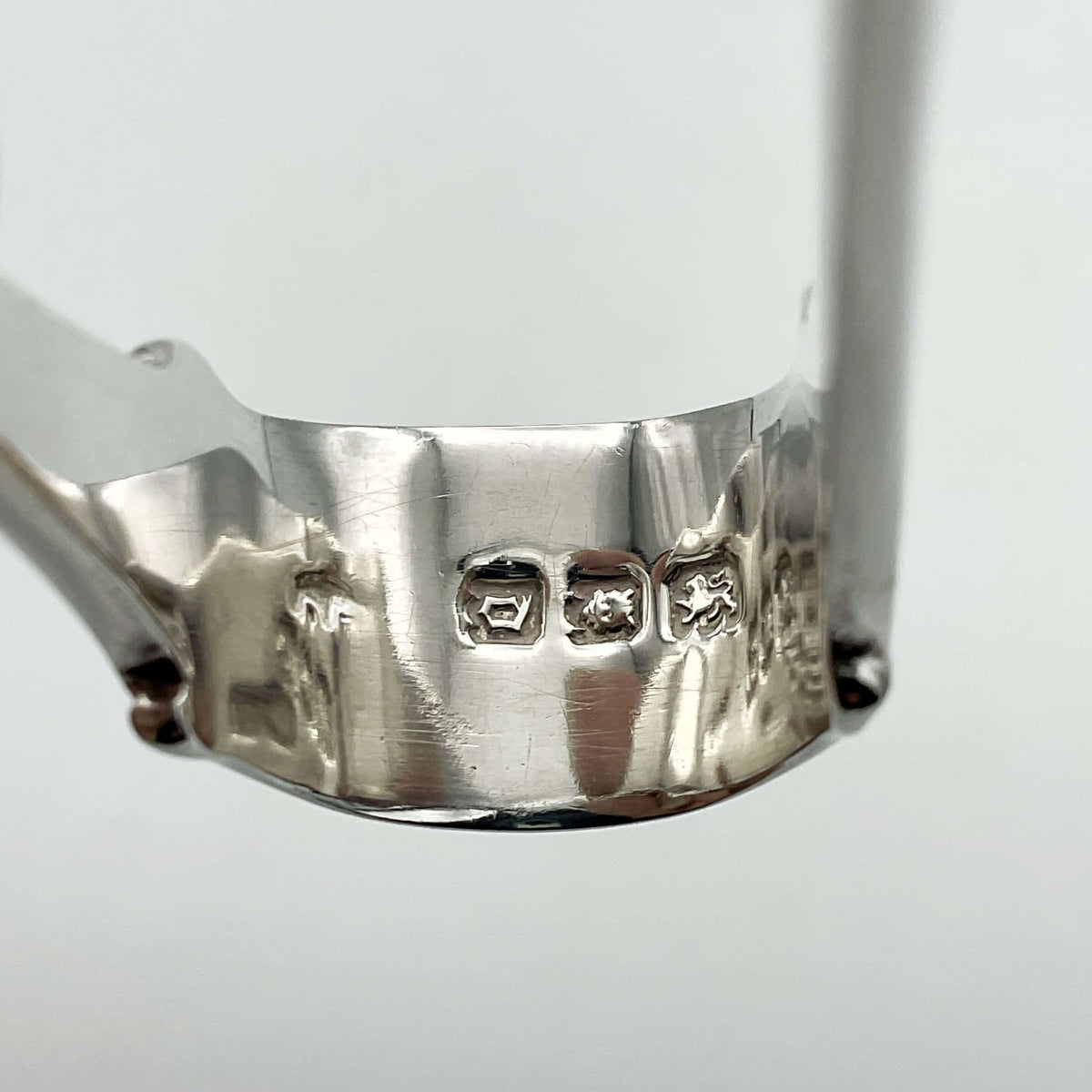 the end og silver sugar tongs showing hallmarks