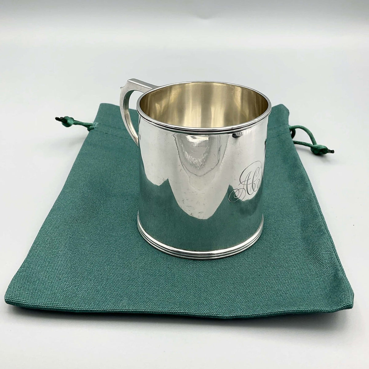 Antique Edwardian silver Christening Cup with hallmarks from 1907, featuring intricate engravings and a classic design.