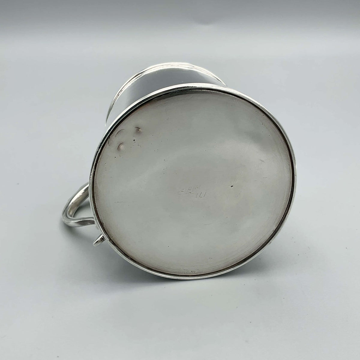 Antique Edwardian silver Christening Cup with hallmarks from 1907, ornate design, and engraved details.
