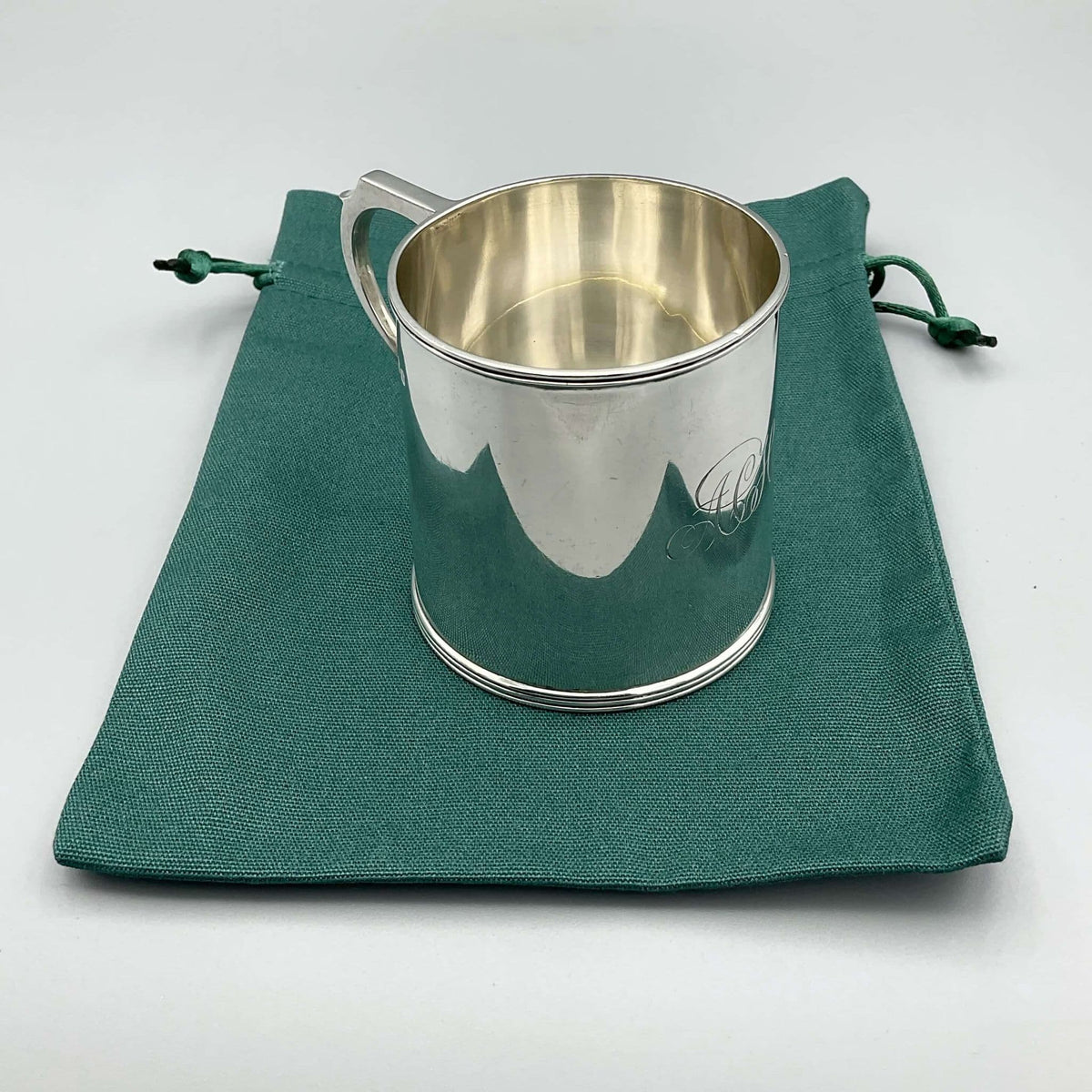 Antique Edwardian silver Christening cup with hallmarks from 1907, ornate design, and engraved details.