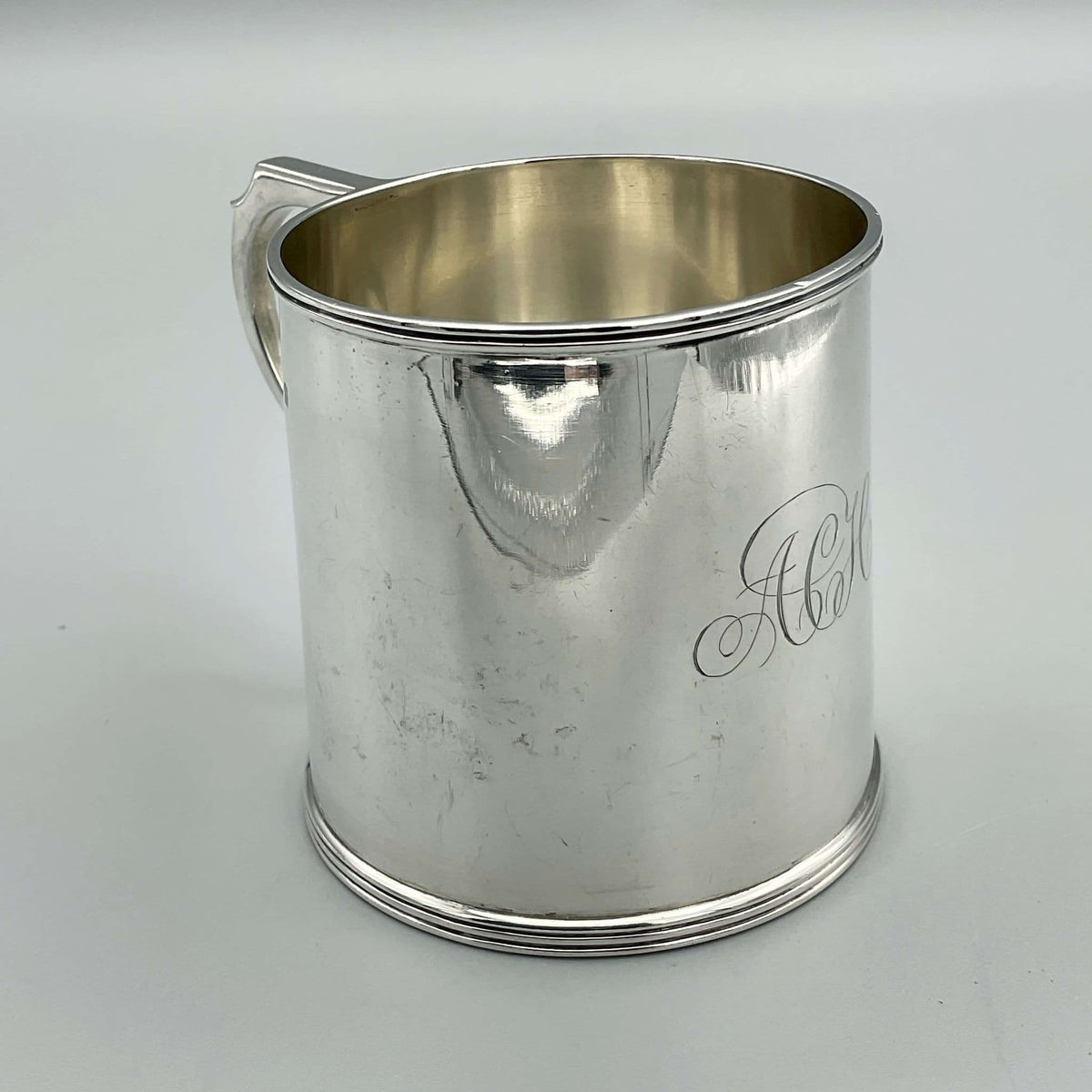 Antique Edwardian silver Christening Cup with hallmarks from 1907, featuring intricate engravings and a classic design.