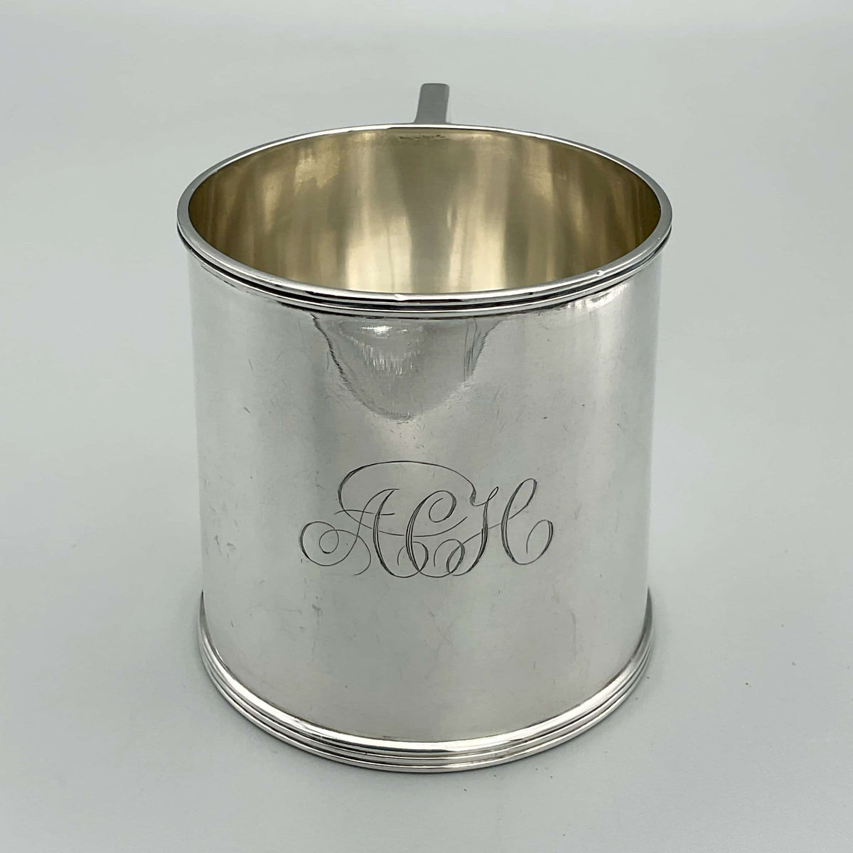 Antique Edwardian silver Christening cup with hallmarks from 1907, featuring intricate engravings and a classic design.