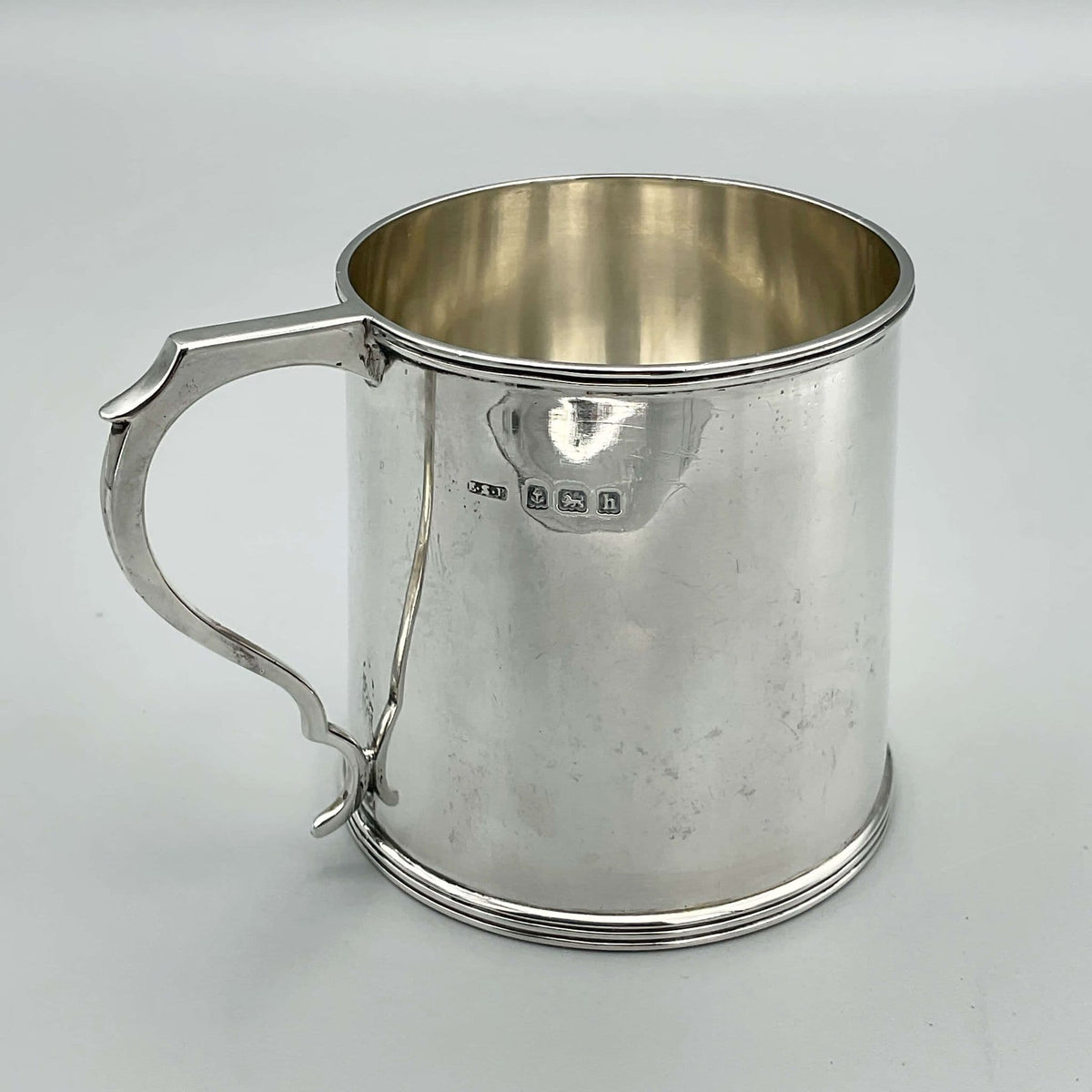 Antique Edwardian silver Christening Cup hallmarked 1907 with intricate engraved details, crafted by Beeches Vintage.