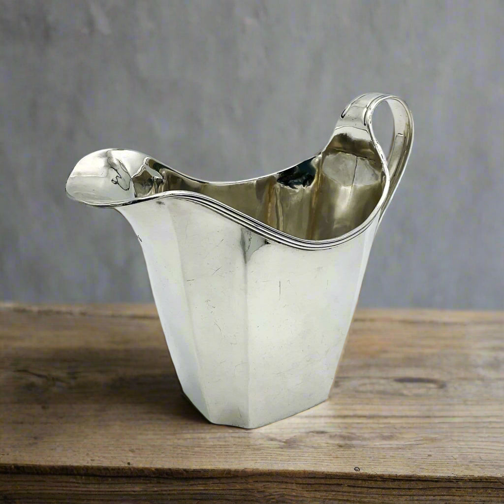 Silver jug on a wood table 