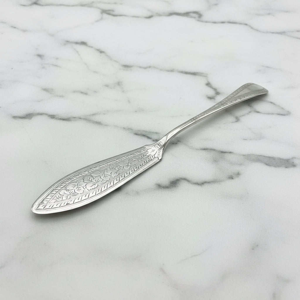 silver plated butter knife on a marble worktop