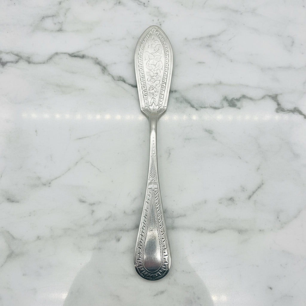 silver plated butter knife on a marble surface