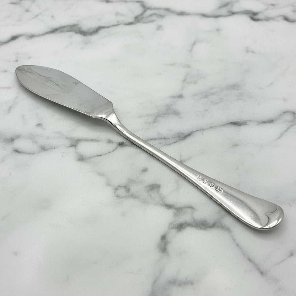 butter knife upside down on a marble worktop