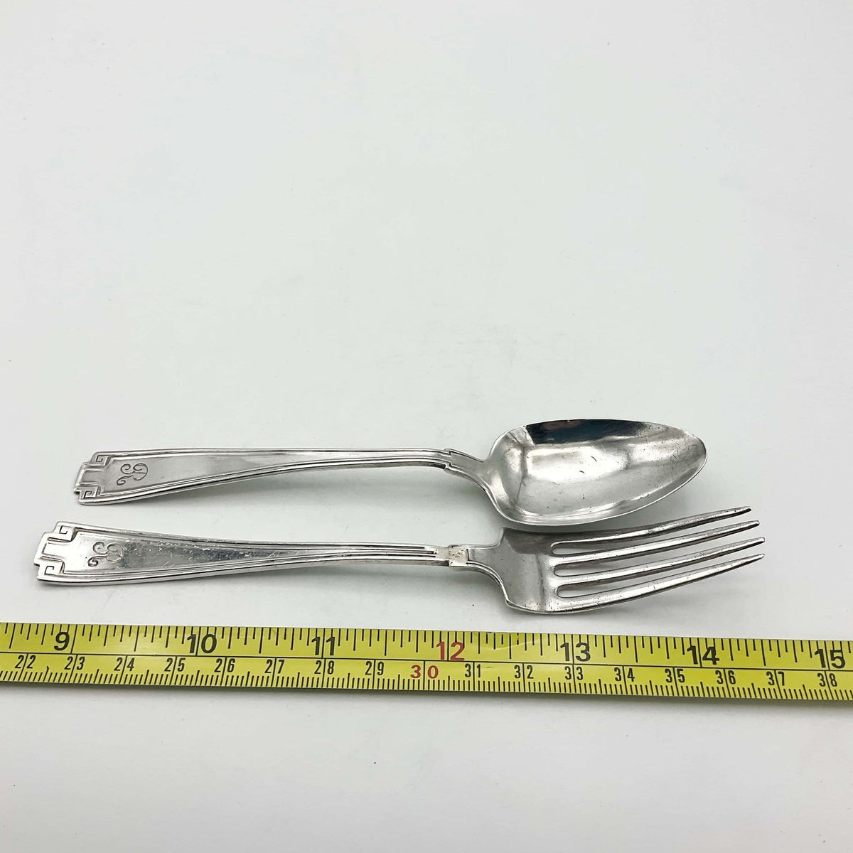 Antique small silver spoon and fork set by Beeches Vintage, perfect for christening gifts, showcasing intricate vintage craftsmanship.