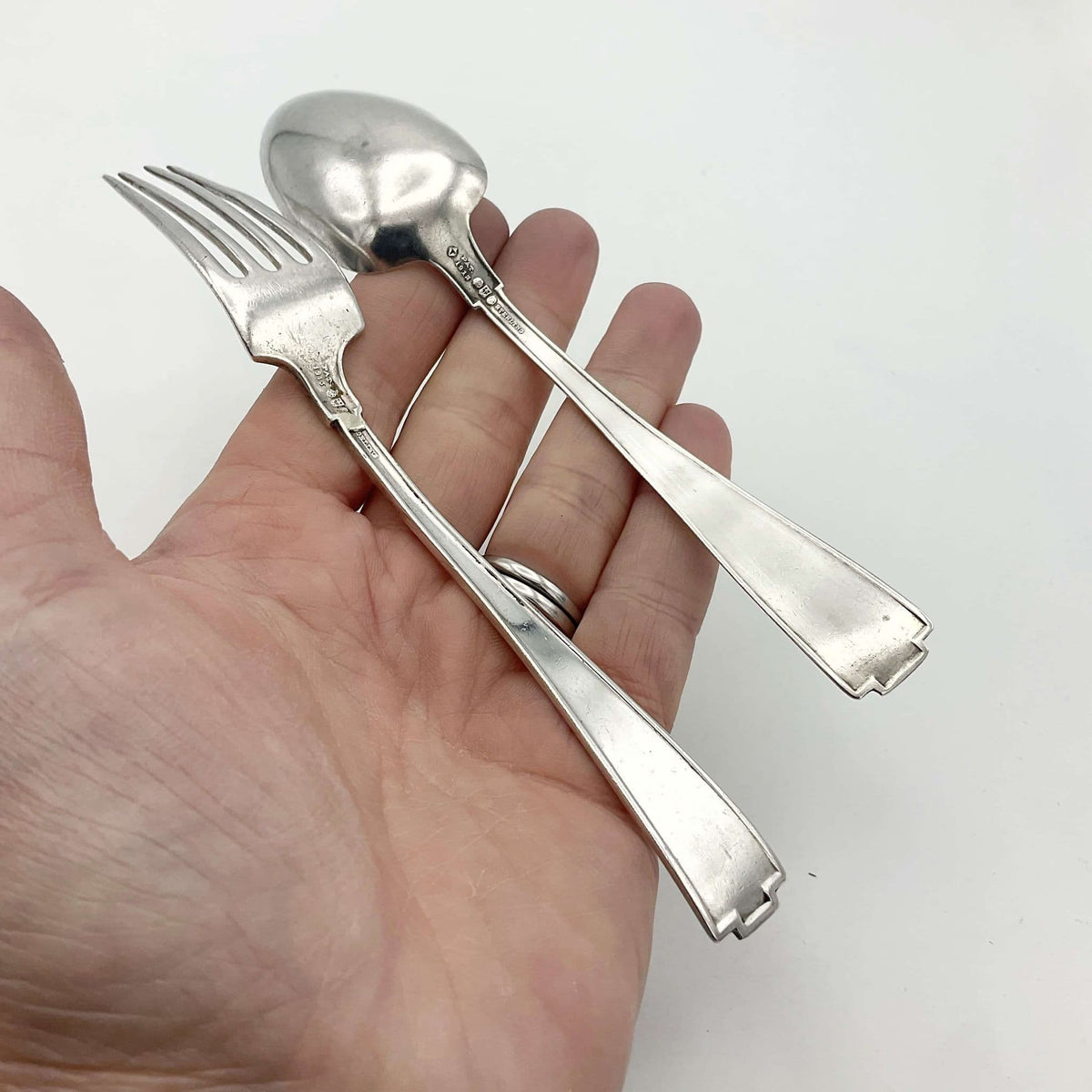 Antique small silver spoon and fork set by Beeches Vintage, perfect for christening gifts, with intricate vintage detailing.