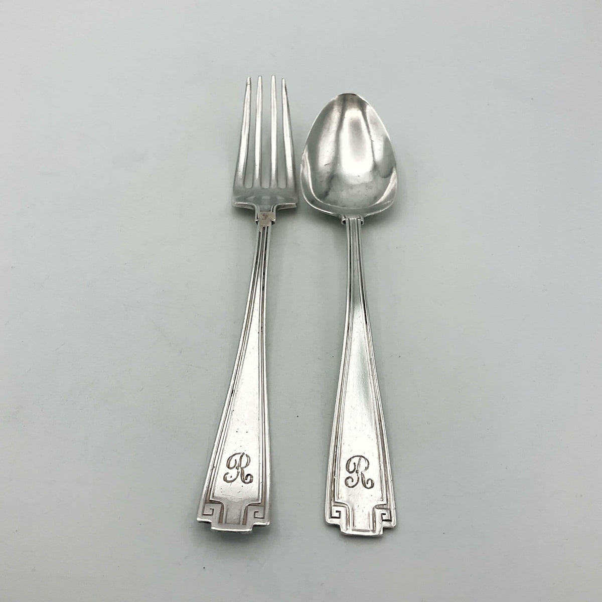 Antique small silver spoon and fork set from Beeches Vintage, perfect as a christening gift, with intricate vintage detailing.