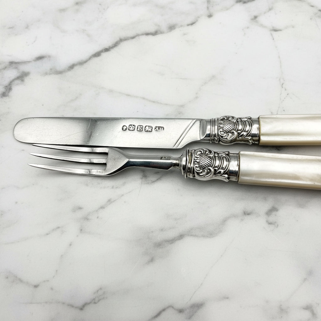 silver knife and fork on marble background