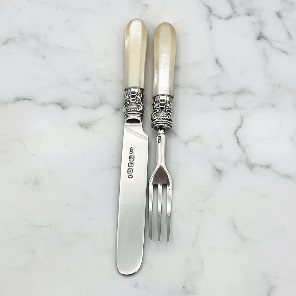 silver knife and fork on marble background